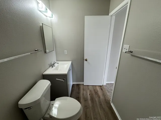 a white toilet sitting next to a bathroom sink