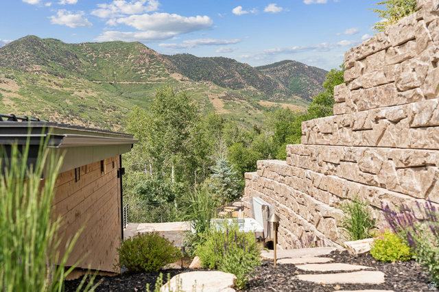 1400 Weber Wild Road Oakley, UT 84055 - Photo 46 of 55 Tiered stone retaining walls define the landscape, featuring integrated lighting and diverse plantings