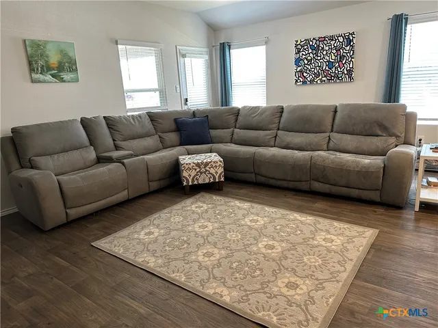 a living room with furniture and a rug