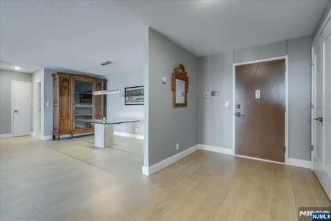 an empty room with closet and windows