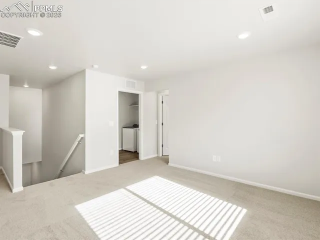 a view of a room with a hallway and stairs