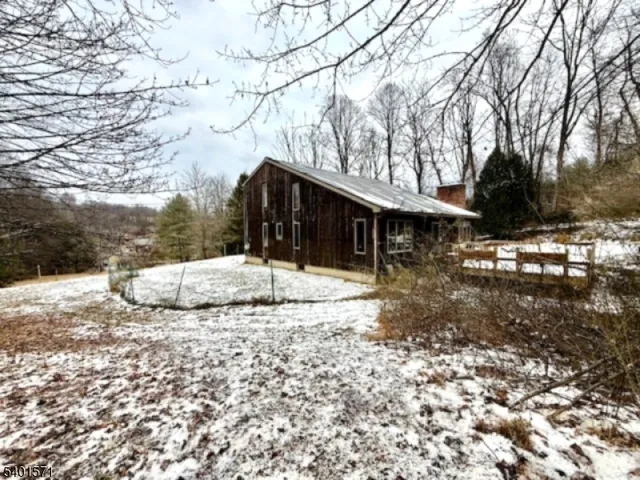 a view of a house with a snow in the yard
