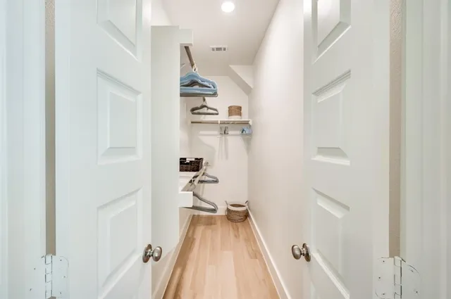 a view of a room with wooden floor and staircase