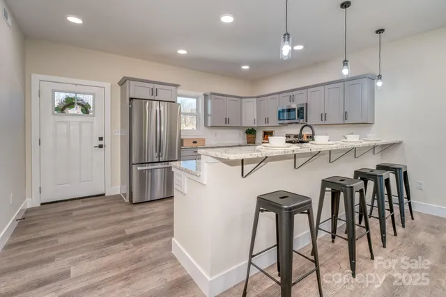a kitchen with kitchen island wooden cabinets and stainless steel appliances