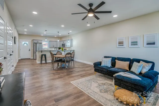 a living room with furniture and kitchen view