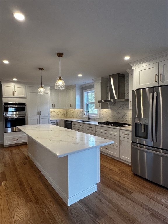 56 Dudley Road Billerica, MA 01821 - Photo 4 of 29 a large kitchen with stainless steel appliances kitchen island a stove and a refrigerator