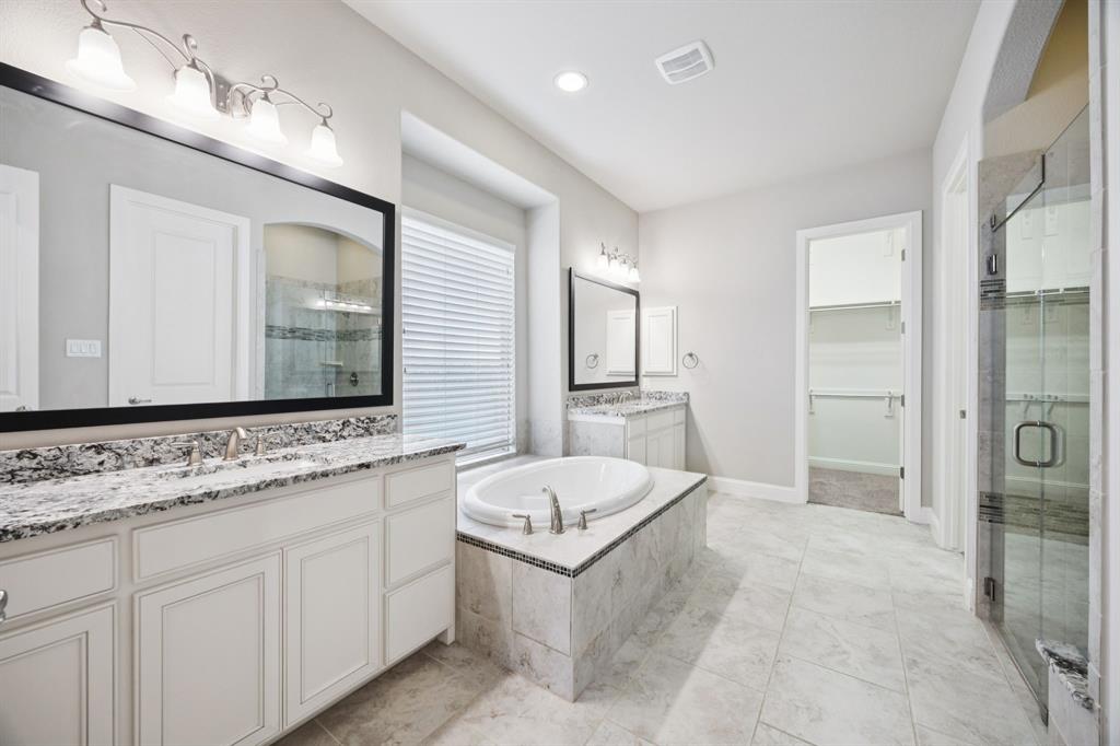 965 Touchstone Road Frisco, TX 75036 - Photo 17 of 36 a bathroom with a granite countertop sink mirror and bathtub