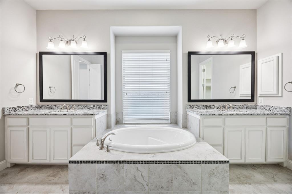965 Touchstone Road Frisco, TX 75036 - Photo 19 of 36 a bathroom with a sink and a mirror