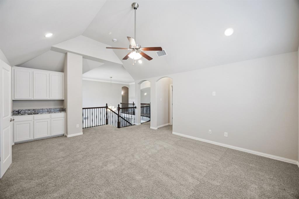 965 Touchstone Road Frisco, TX 75036 - Photo 21 of 36 a view of a kitchen with a sink and a refrigerator