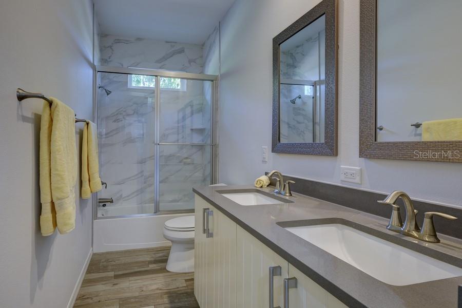 4436 Bliss Road Sarasota, FL 34233 - Photo 18 of 25 a bathroom with a granite countertop sink a toilet and shower