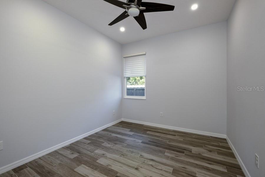 4436 Bliss Road Sarasota, FL 34233 - Photo 20 of 25 wooden floor in an empty room with a window