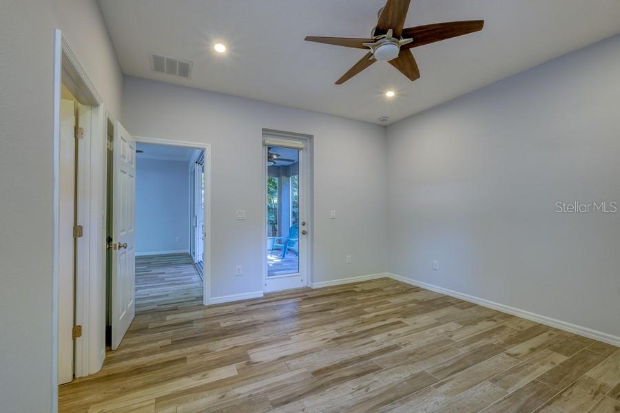 4436 Bliss Road Sarasota, FL 34233 - Photo 24 of 25 an empty room with wooden floor fan and windows