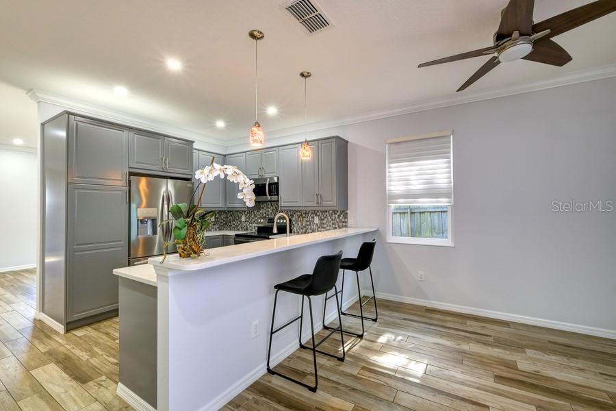 4436 Bliss Road Sarasota, FL 34233 - Photo 6 of 25 a kitchen with kitchen island stainless steel appliances a sink stove and refrigerator