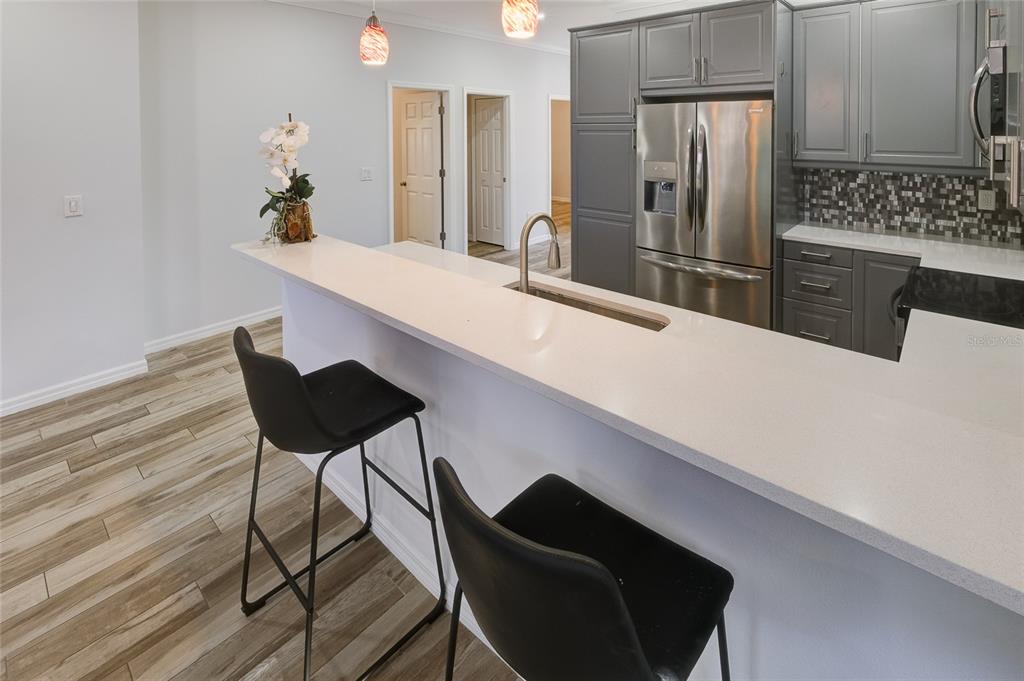 4436 Bliss Road Sarasota, FL 34233 - Photo 9 of 25 a kitchen with stainless steel appliances dining table and chairs