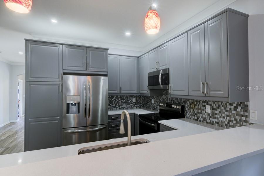 4436 Bliss Road Sarasota, FL 34233 - Photo 10 of 25 a kitchen with stainless steel appliances a refrigerator and a sink