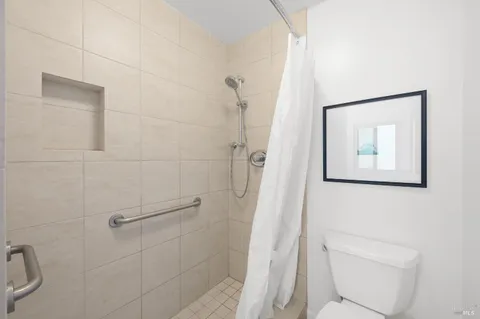 a bathroom with a toilet and a shower