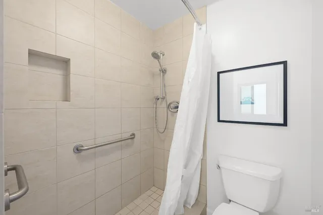 a bathroom with a toilet and a shower