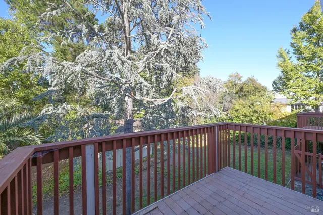 a balcony with wooden floor and fence