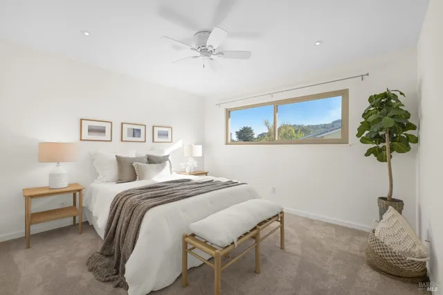 a bedroom with a bed and a plant