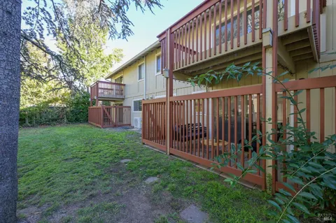 a view of a house with backyard and porch