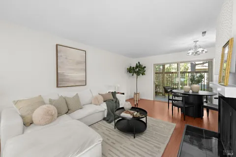 a living room with furniture and wooden floor