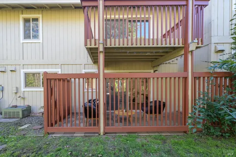 a view of a house with a small yard and wooden fence