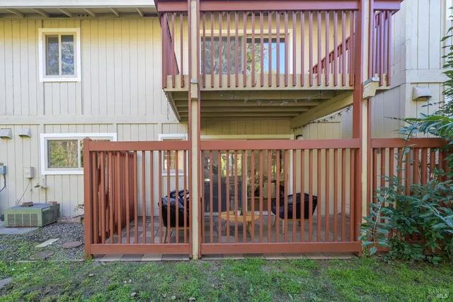 a view of a house with a small yard and wooden fence