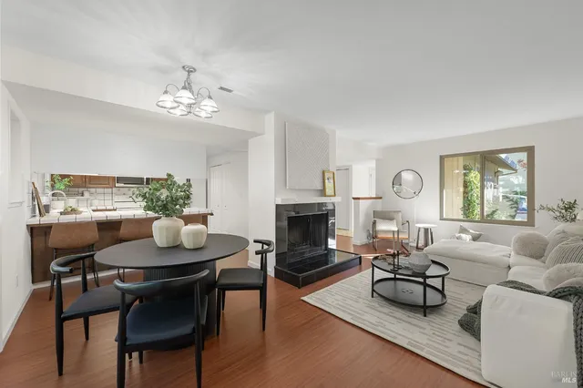 a living room with furniture a fireplace and a table