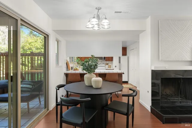 a dining room with furniture a window and a chandelier