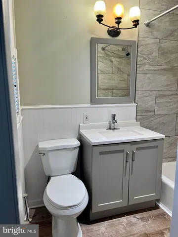 a bathroom with a sink toilet and mirror