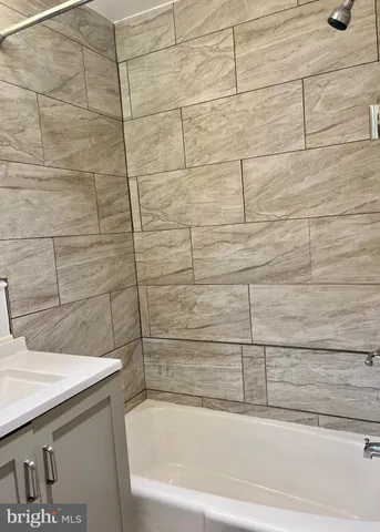 a bathroom with a bathtub and shower