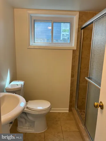 a white toilet sitting next to a window