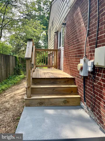 a view of backyard with outdoor seating and wooden fence