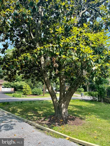 a backyard of a house with a yard and outdoor seating