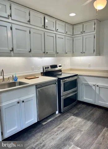 a kitchen with stainless steel appliances granite countertop a sink and a stove