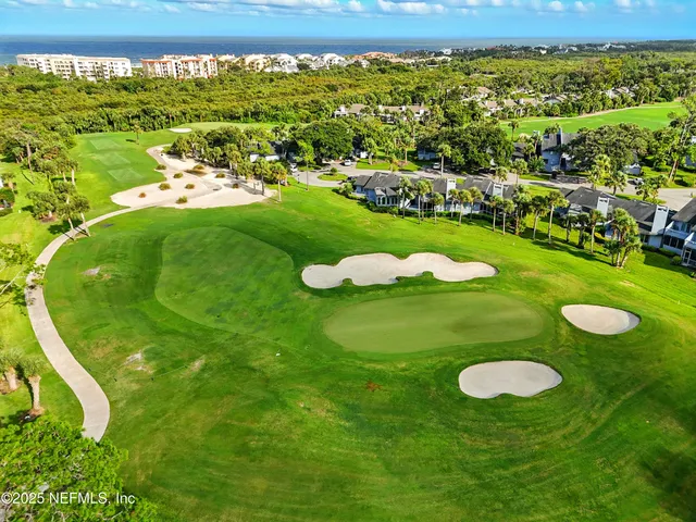 a view of a golf course with an ocean