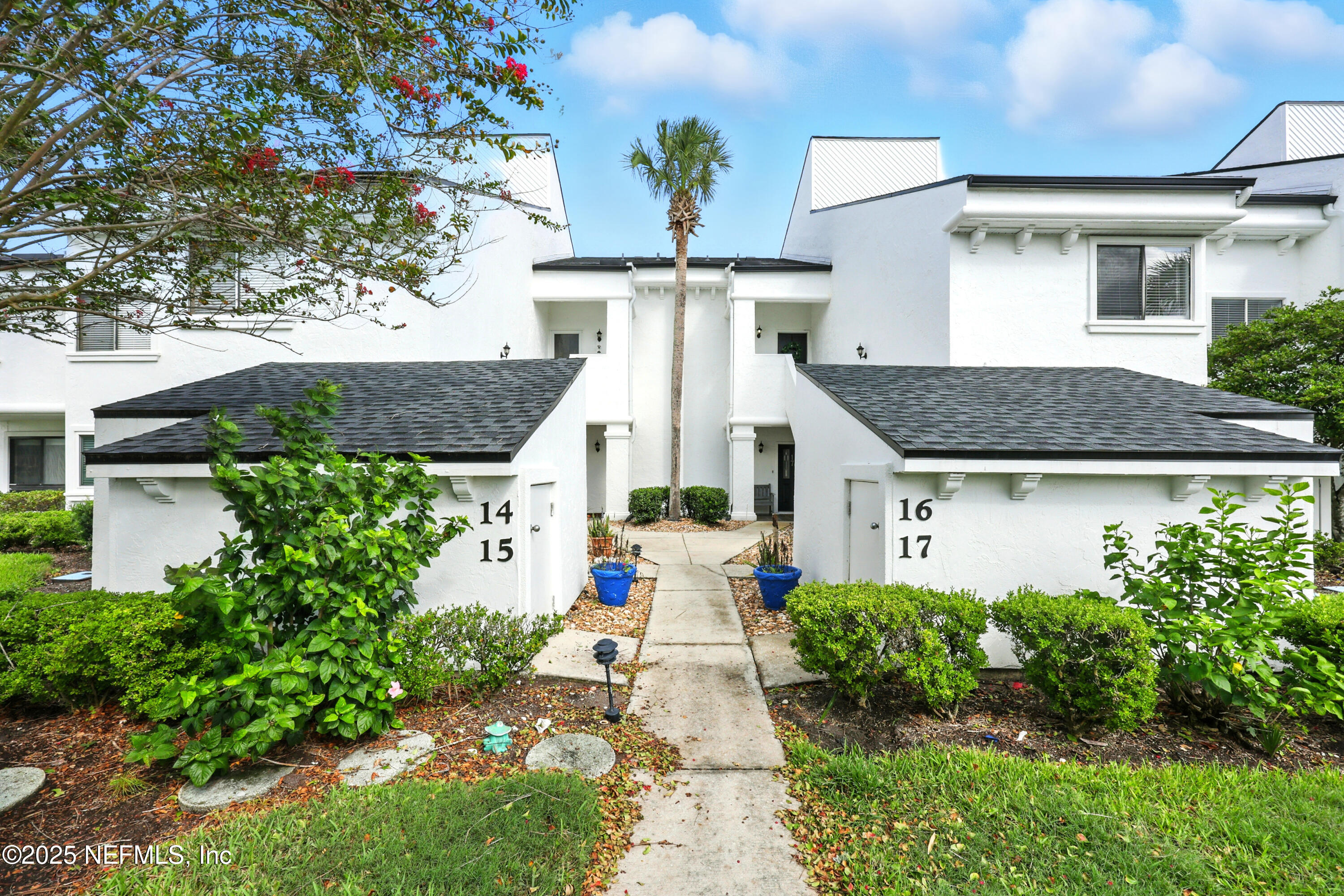 16 Cove Road Ponte Vedra Beach, FL 32082 - Photo 27 of 47 a view of a white house with large windows and a yard with plants