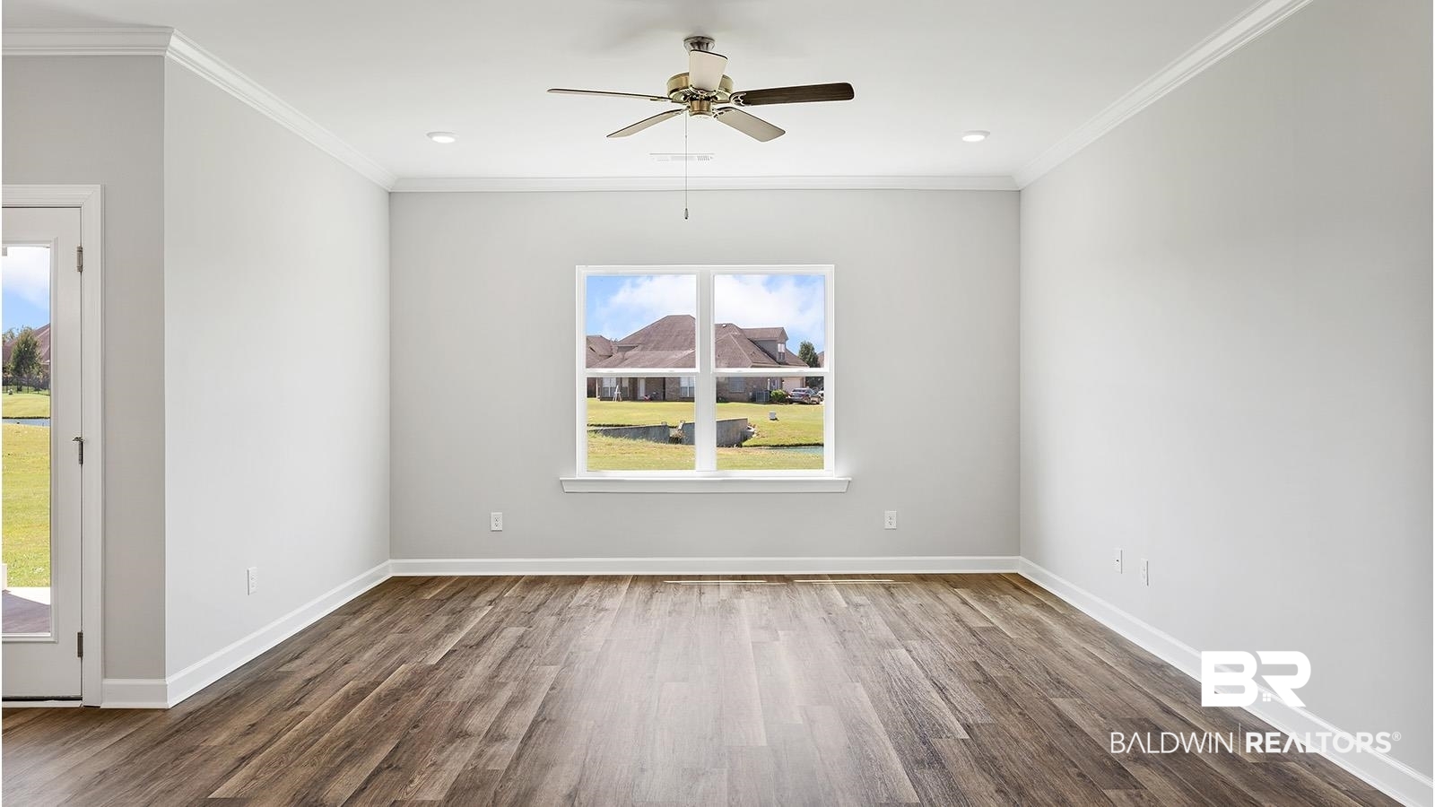 30567 Asheville Road Daphne, AL 36527 - Photo 9 of 29 Empty room with wood finished floors, ornamental molding, and a ceiling fan