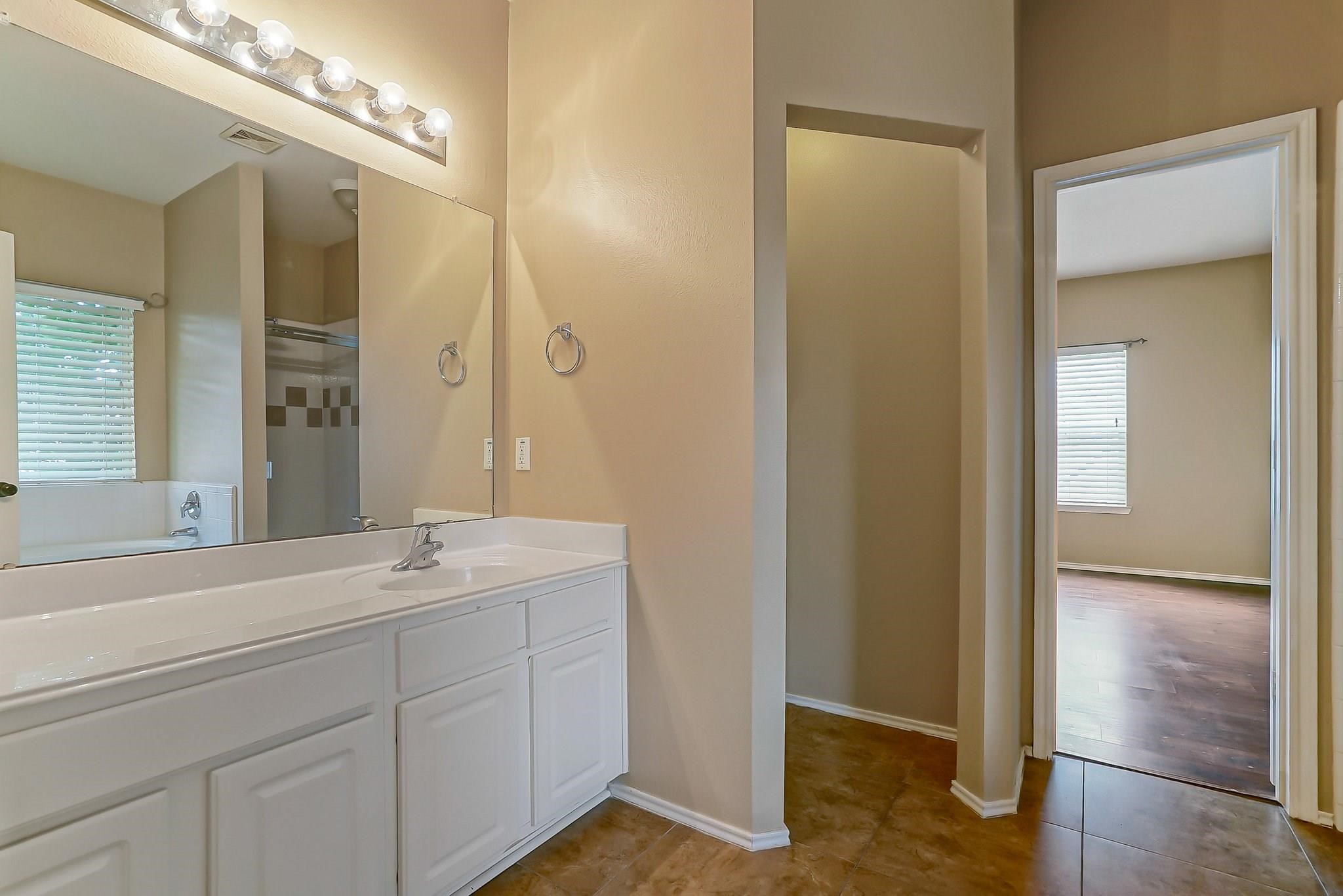 3410 Azalea Sands Drive Spring, TX 77386 - Photo 13 of 40 a bathroom with a double vanity sink and a mirror