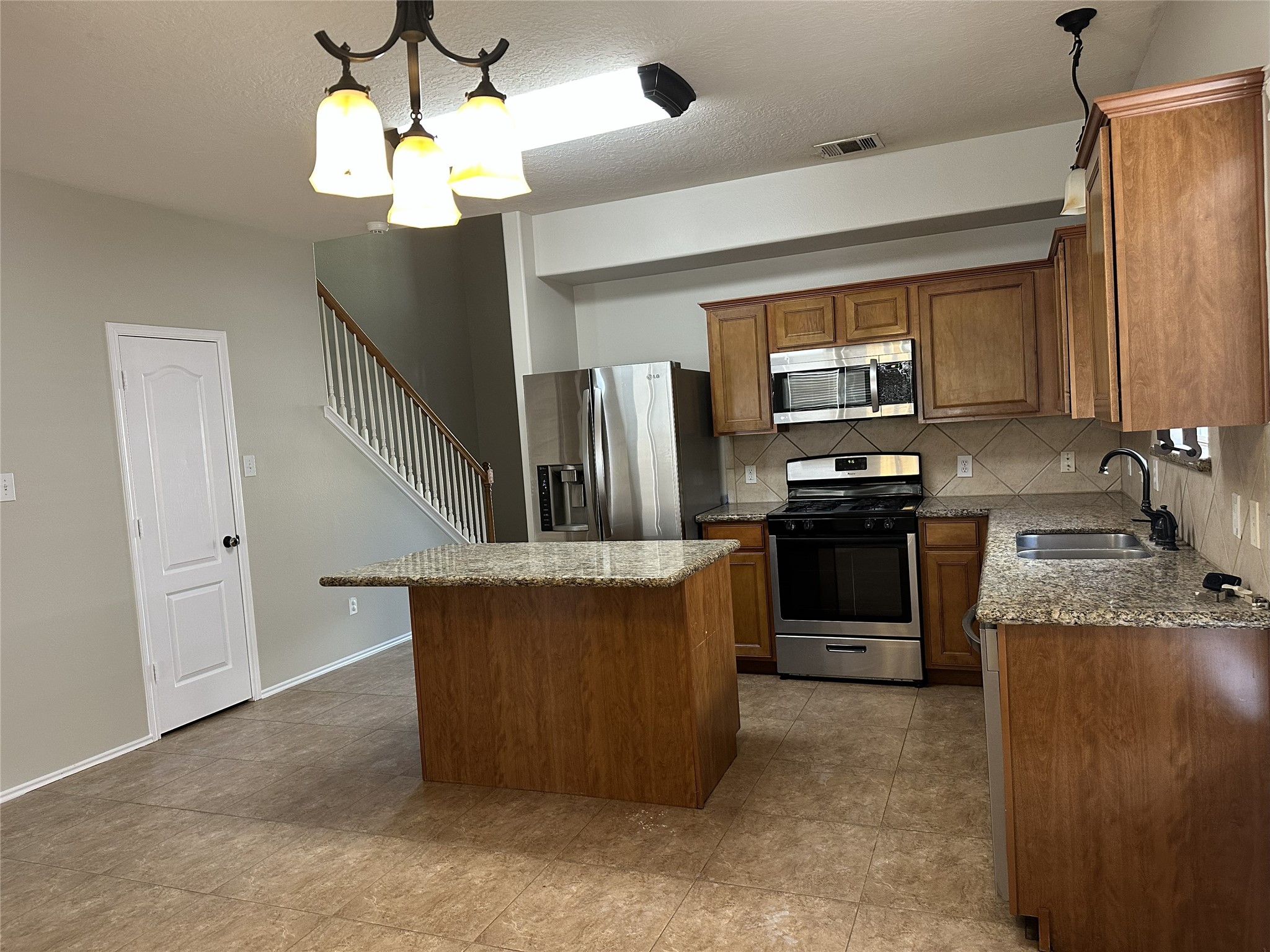 3410 Azalea Sands Drive Spring, TX 77386 - Photo 25 of 40 a kitchen with stainless steel appliances granite countertop a sink a stove and a refrigerator