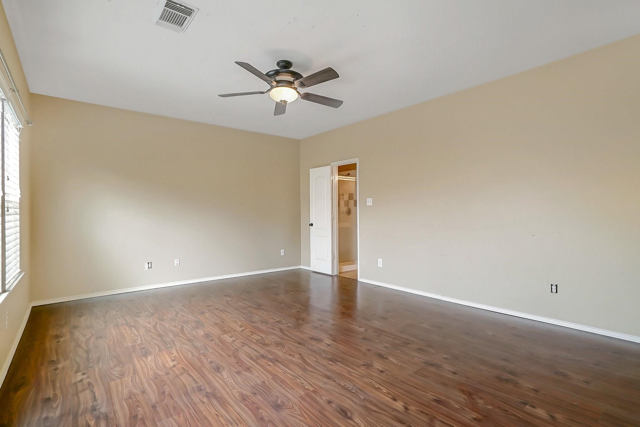 3410 Azalea Sands Drive Spring, TX 77386 - Photo 10 of 40 a view of an empty room with wooden floor and a window