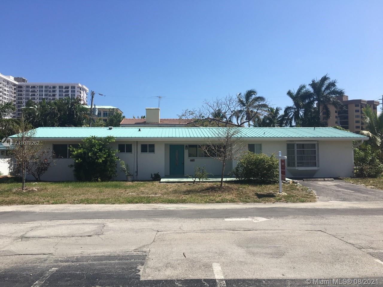 524 North Riverside Drive Pompano Beach, FL 33062 - Photo 2 of 35 a front view of house with yard