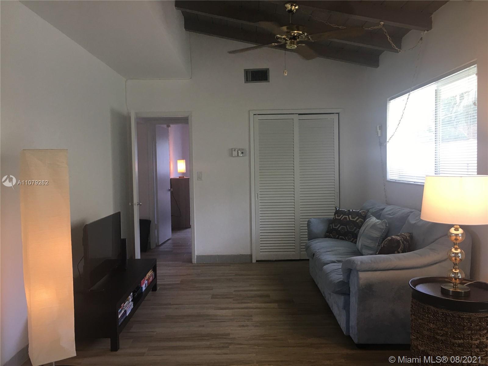 524 North Riverside Drive Pompano Beach, FL 33062 - Photo 12 of 35 a living room with furniture and a flat screen tv