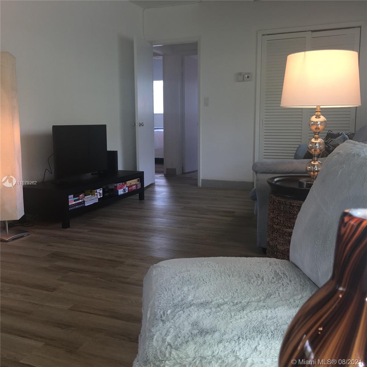 524 North Riverside Drive Pompano Beach, FL 33062 - Photo 13 of 35 a living room with furniture and a flat screen tv