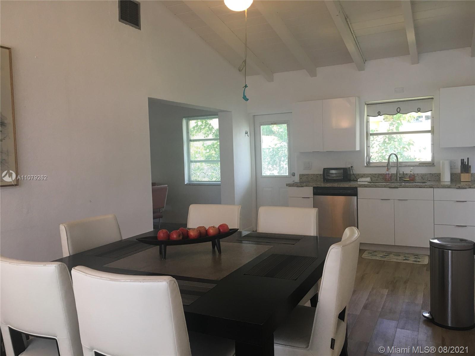 524 North Riverside Drive Pompano Beach, FL 33062 - Photo 18 of 35 a kitchen with a dining table chairs and sink