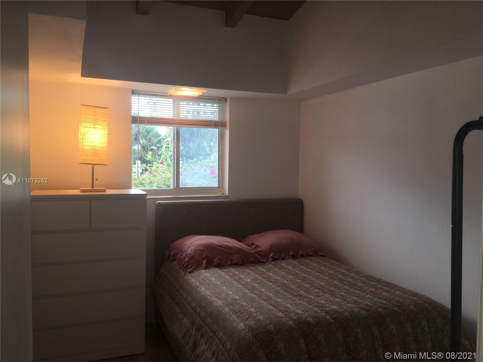 524 North Riverside Drive Pompano Beach, FL 33062 - Photo 23 of 35 a bedroom with a bed and a window