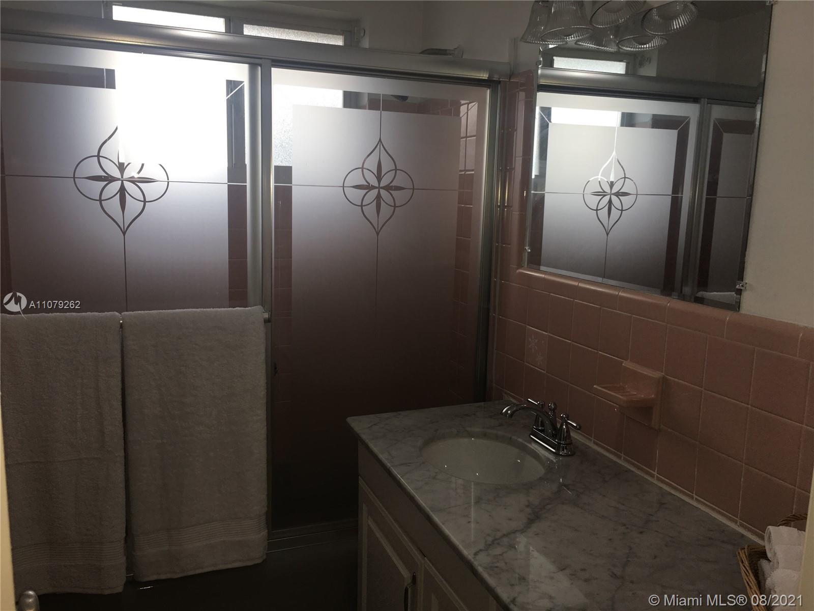 524 North Riverside Drive Pompano Beach, FL 33062 - Photo 24 of 35 a bathroom with a granite countertop sink and mirror