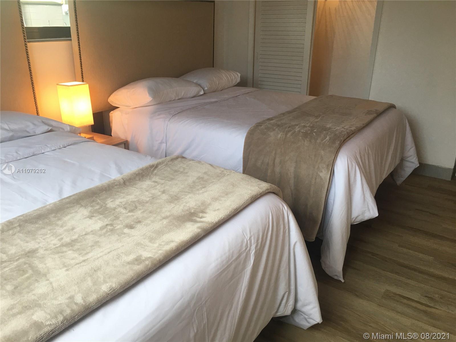 524 North Riverside Drive Pompano Beach, FL 33062 - Photo 26 of 35 a bedroom with two beds and wooden floor