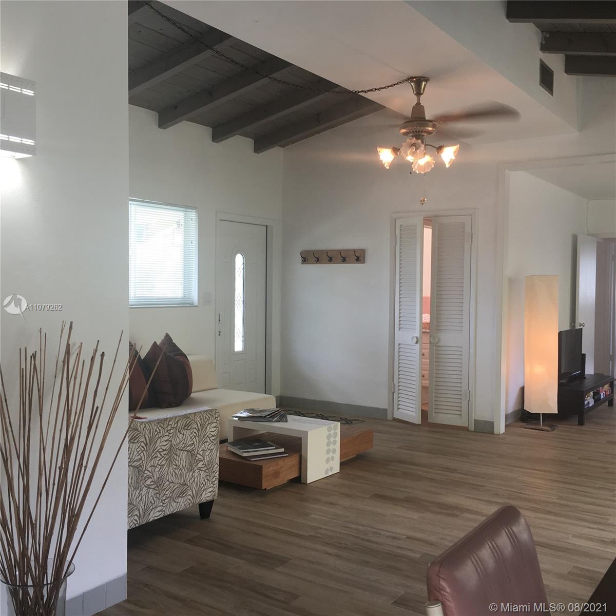 524 North Riverside Drive Pompano Beach, FL 33062 - Photo 4 of 35 a living room with furniture and a wooden floor