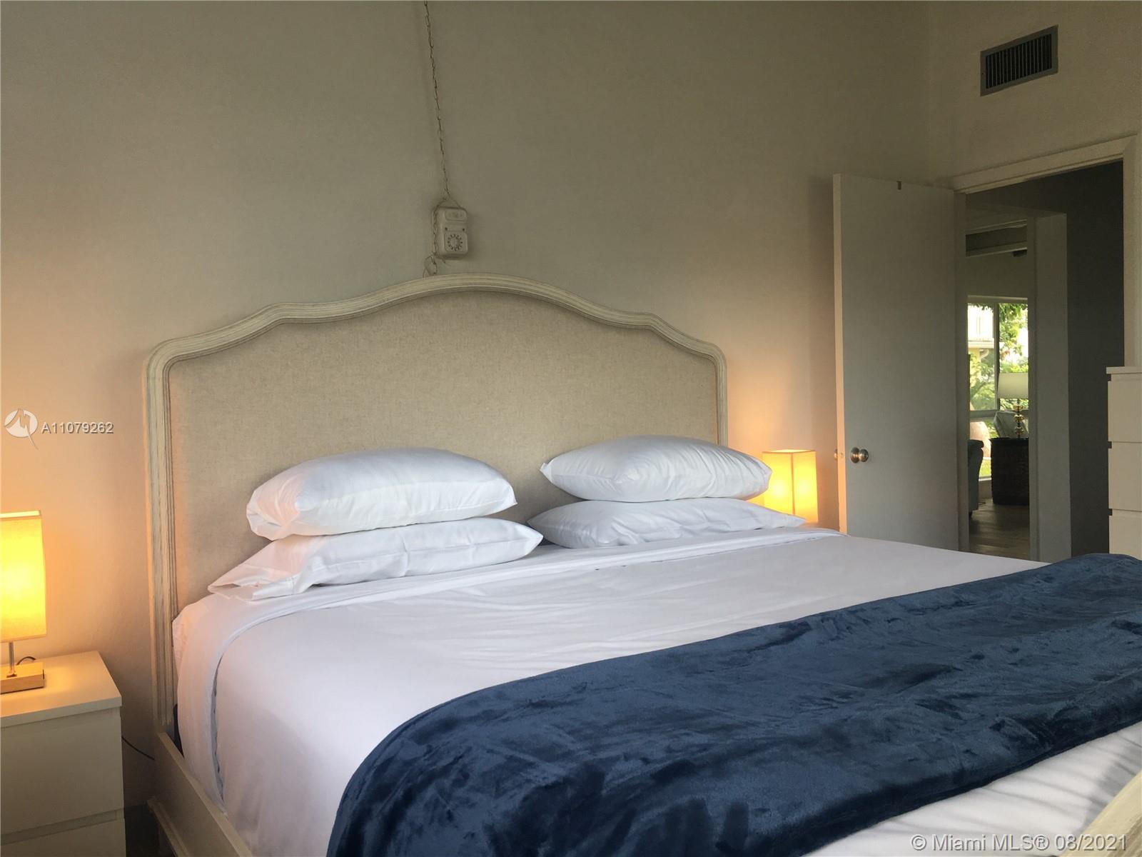 524 North Riverside Drive Pompano Beach, FL 33062 - Photo 32 of 35 a bedroom with two beds and a chandelier